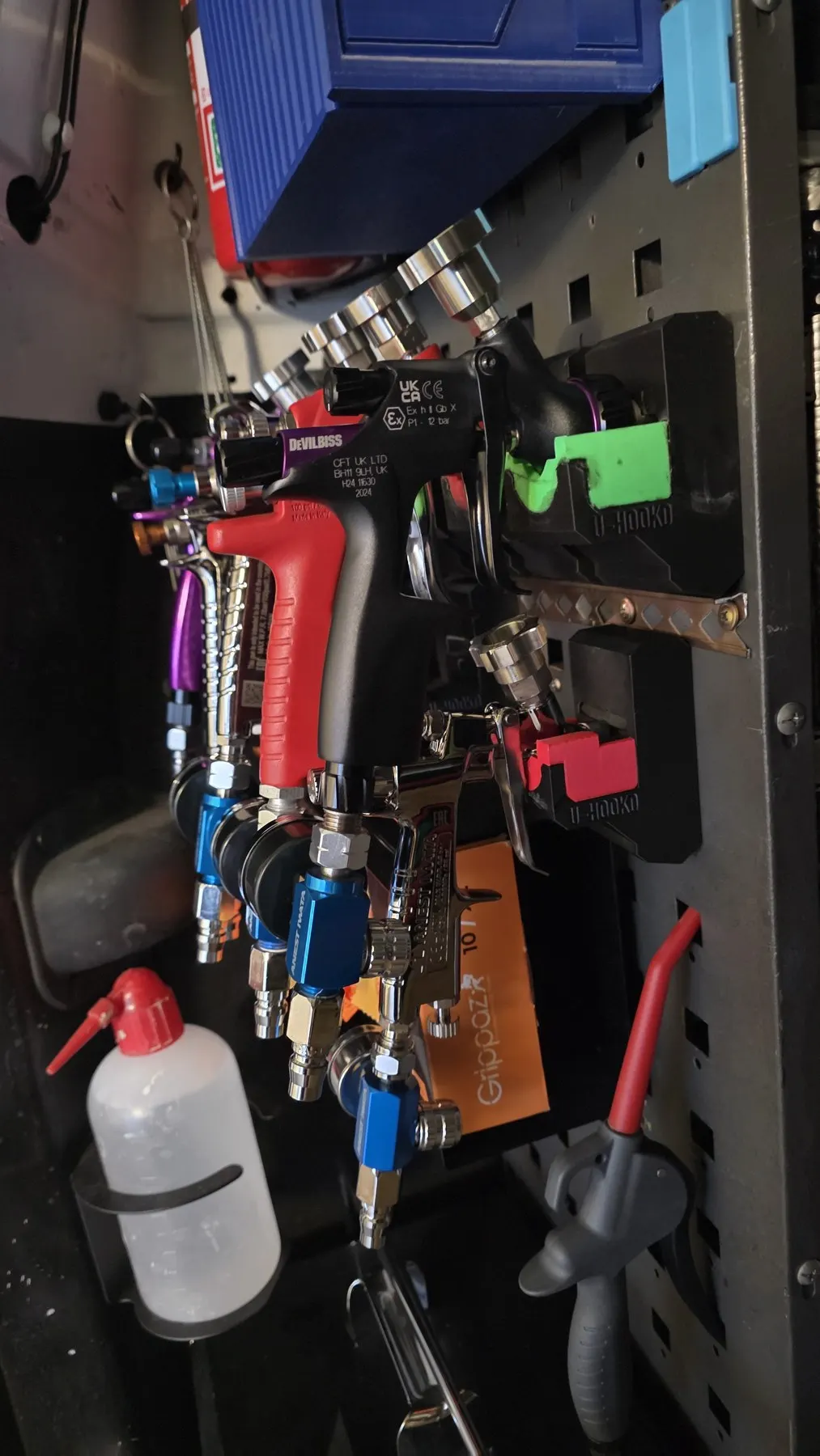 Professional spray guns organised inside our mobile repair van