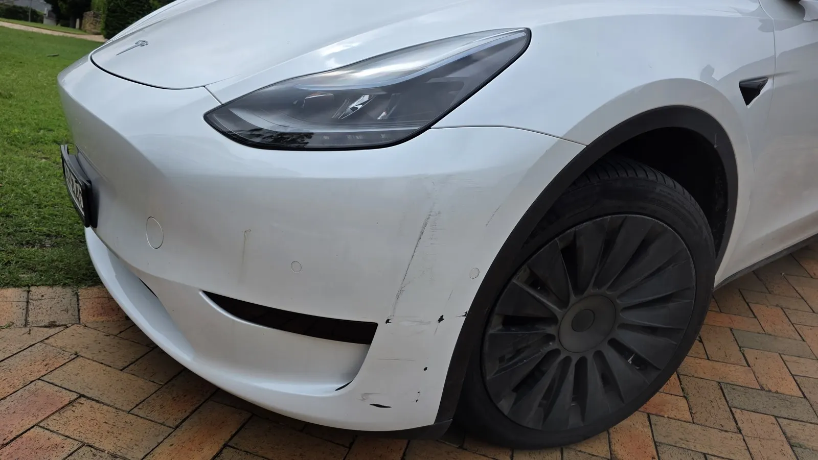 White electric car paint scuffs before repair