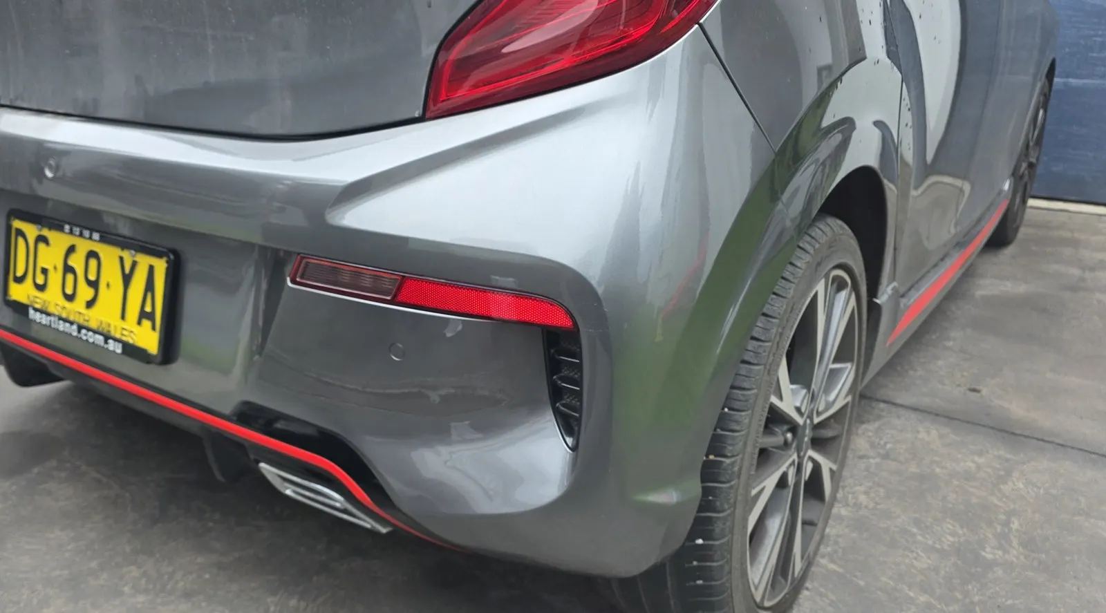 Grey car rear bumper repair after repair