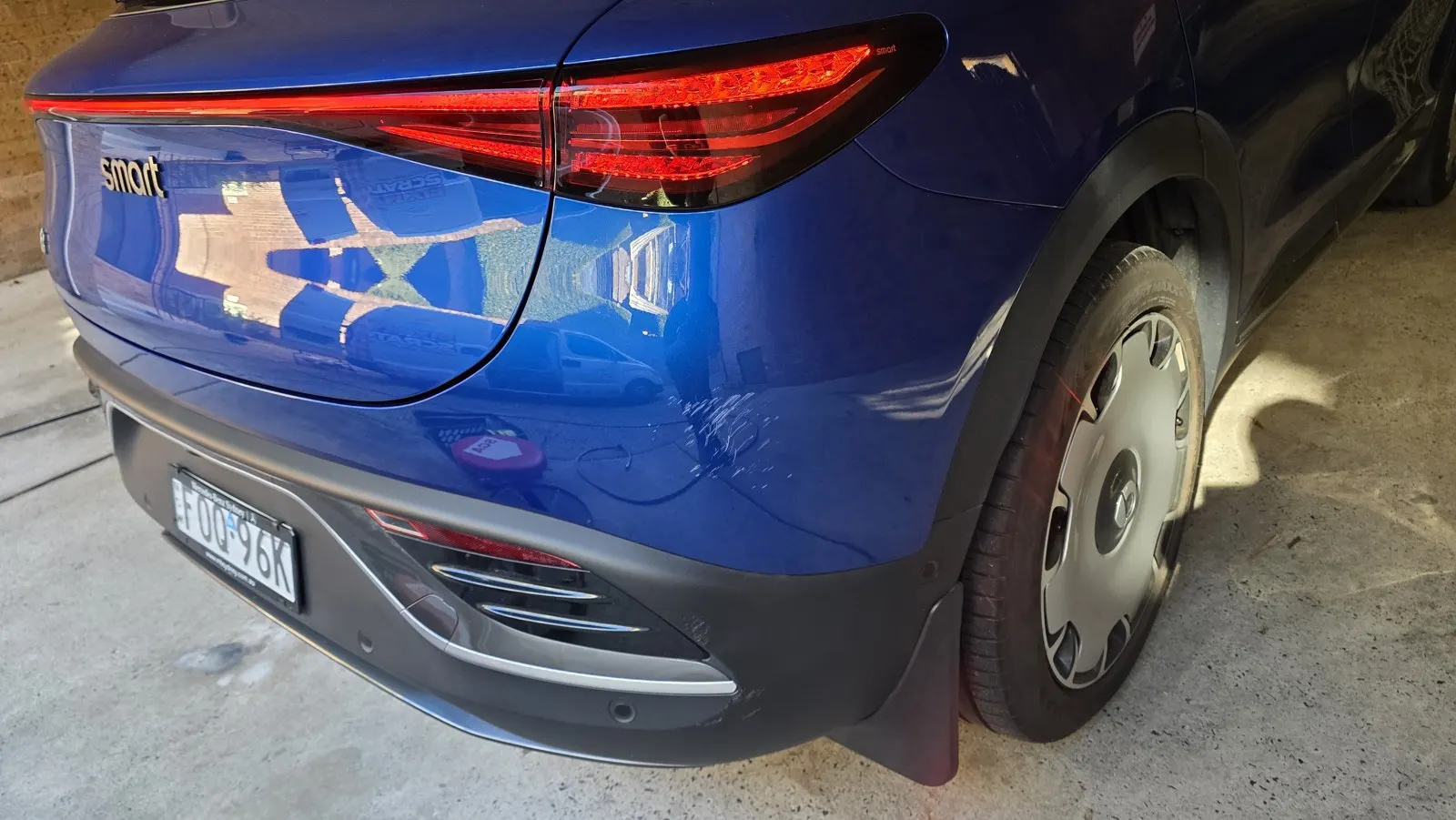 Blue car paint and panel scuffs before repair