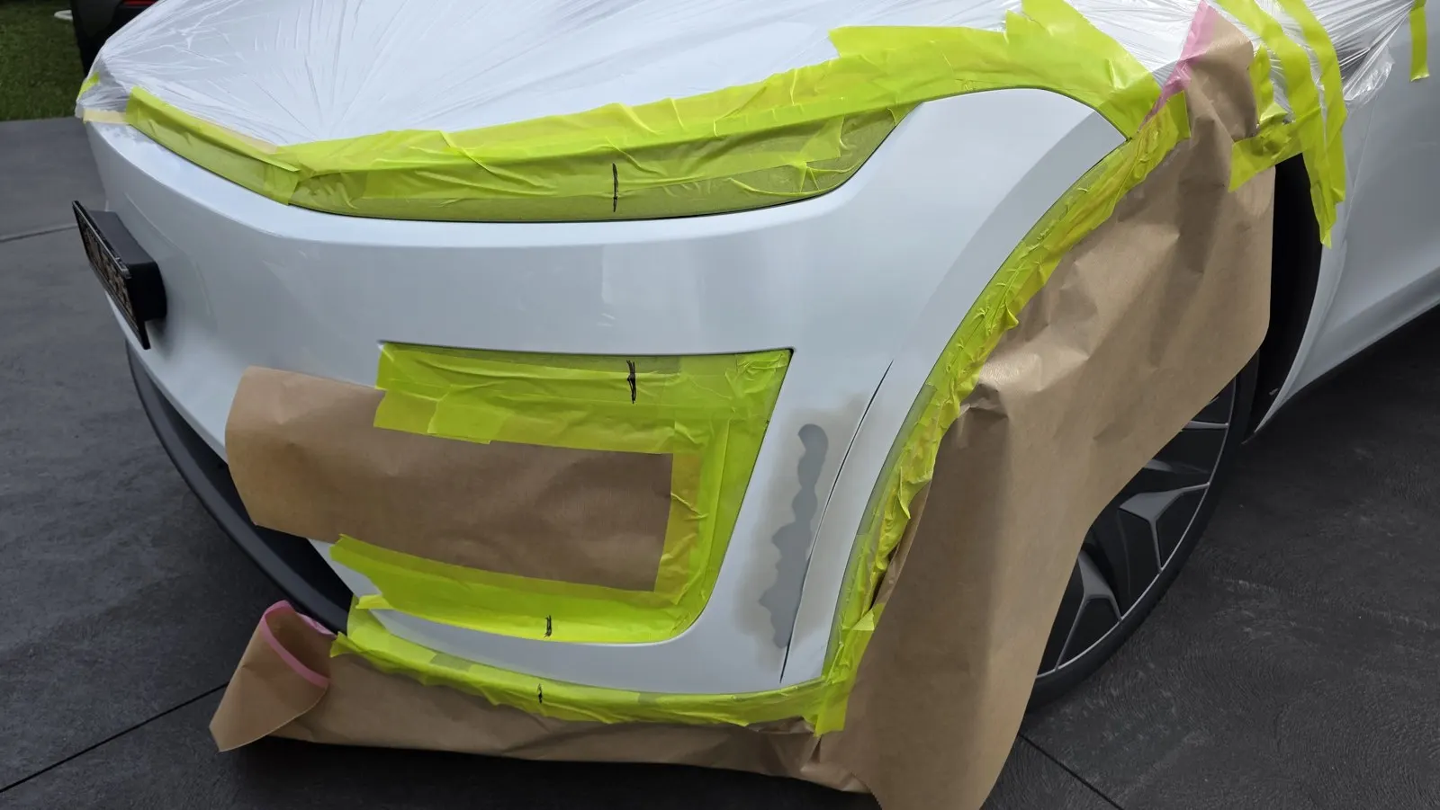 White SUV bumper refinishing before repair