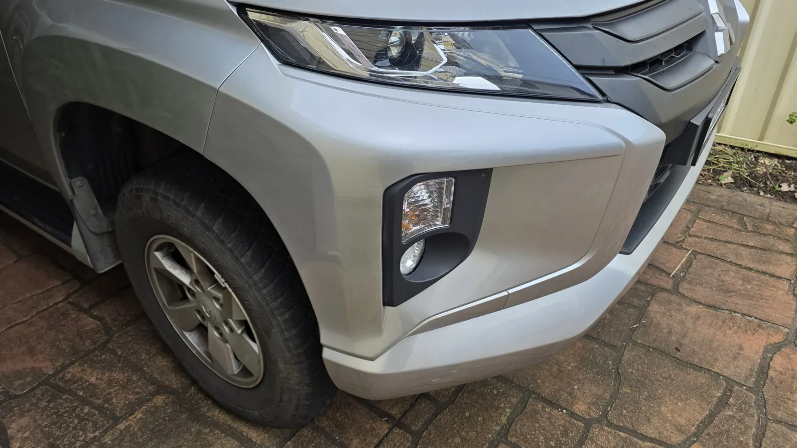 Silver SUV bumper refinishing after repair