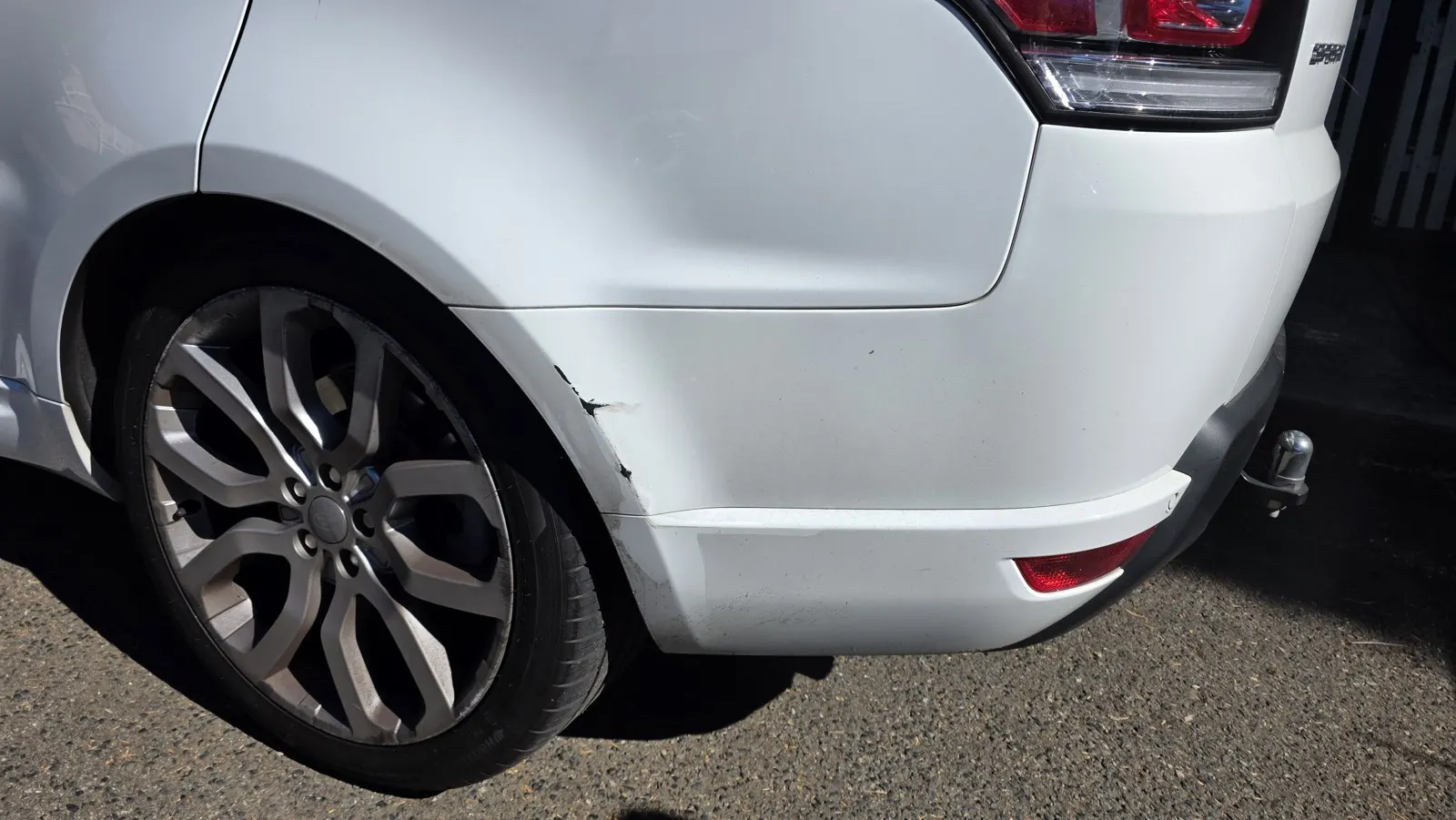 Silver vehicle rear bumper scuffs after repair